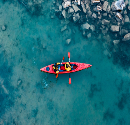 two athletic man floats red boat